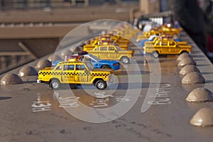 Toy Taxis on Brooklyn Bridge Beam