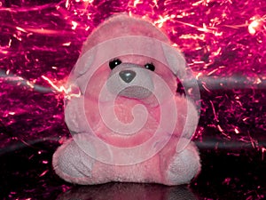 toy teddy bear isolated on pink light sparkles background