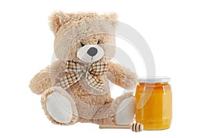 Toy teddy bear isolated on white with honey
