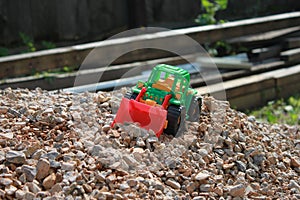 Toy tractor on a pile of rubble, kids game