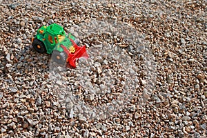 Toy tractors on a pile of rubble, kids game