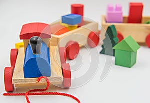 Toy train made of colorful wood on a white background