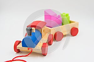 Toy train made of colorful wood on a white background