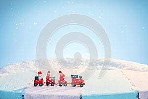 Toy train on a snowy sunny day. Winter travel concept
