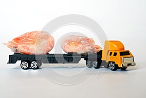 A toy truck carries a pair of frozen shrimps. Seafood delivery