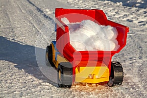 Toy truck removes snow on the road