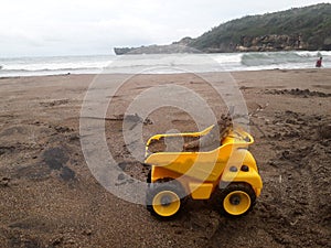 Toy truck on the sand baron beach, Yogyakarta, Indonesia