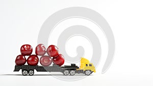 Toy truck with a trailer transports red ripe sweet cherry. White background. The concept of delivering oversized items and fresh