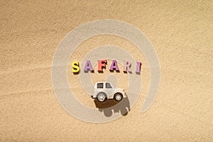 Toy white safari jeep on the sands of the beach, desert dunes. Concept.