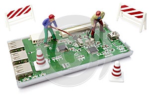 toy workers repairing computer