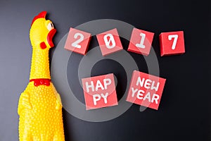 Toy yellow shrilling chicken and Happy new year 2017 number on r