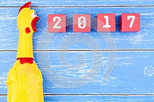 Toy yellow shrilling chicken and Happy new year 2017 number on r