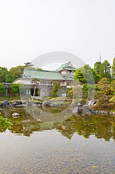 Toyama castle with beautiful garden and reflection in water.