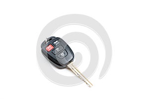 A Toyota car key is isolated on a white background on a downward slanted angle. Close up