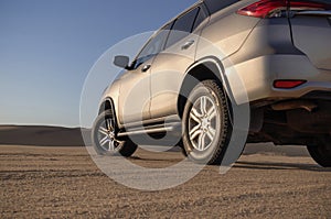 Toyota Fortuner standing in the middle of the Namib desert on a sunny day