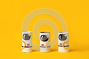 Toys astronaut on yellow background with copy space for text. Concept of business launch, start up, handcraft, diy, creative idea