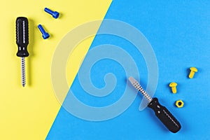 Toys background. Kids construction toys tools on blue and yellow background. Top view