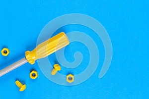 Toys background. Kids construction toys tools on light blue and yellow background.