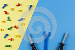 Toys background. Kids construction toys tools on blue and yellow background. Top view