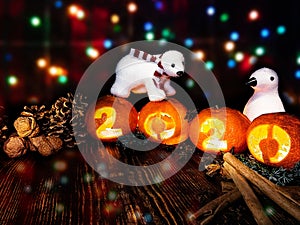 Toys on the background of multi-colored lights of a garland with tangerine lights 2020.