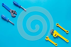 Toys background. Top view of toy tools on blue background