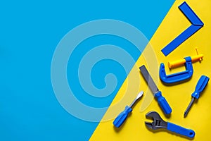 Toys background. Top view of toy tools on blue background