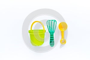 Toys bucket shovel and whisk for sand. Children`s toy summer sea game. Copy space. Flat lay. playground on outdoor