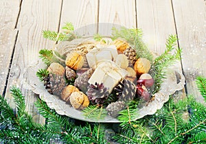 Toys for the Christmas tree and pine cones in a metal bowl, on old wooden background new Year