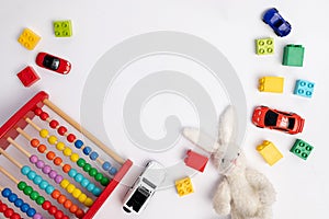 Toys constuctor and cars, top view on white background, place for text