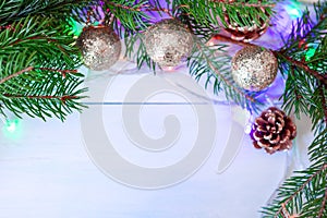 Toys, fir branches and cones with garlands on a wooden blue background
