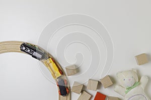 Toys frame with teddy, wooden cubes and toy train on the white background