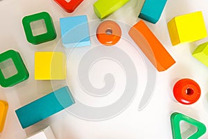 Toys kids background. Wooden cubes with numbers and colorful toy bricks on a white background. frame made of accessories