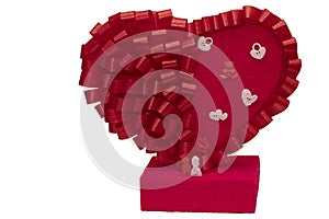 Toys for men and women next to a big red heart on a white background. Family figurines close up. Holiday card for the wedding and