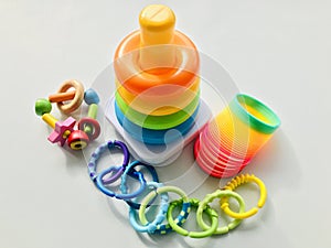 Toys of rainbow colored on greyish white background.