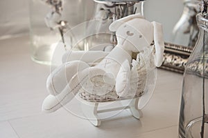 Toys newborns. White rabbit in a little buggy