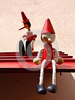 Toys of Pinocchio sitting on a surface attached to the wall