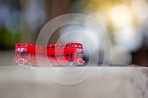 Toys that represent two of the main symbols of the city of London, double-decker bus on blurred background. selective focus and