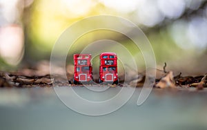 Toys that represent two of the main symbols of the city of London, double-decker bus on blurred background. selective focus and