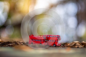 Toys that represent two of the main symbols of the city of London, double-decker bus on blurred background. selective focus and