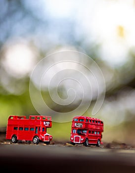 Toys that represent two of the main symbols of the city of London, double-decker bus on blurred background. selective focus and