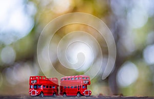 Toys that represent two of the main symbols of the city of London, double-decker bus on blurred background. selective focus and