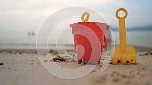 Toys on the sand beach with sea wave select focus shallow depth of field with summer