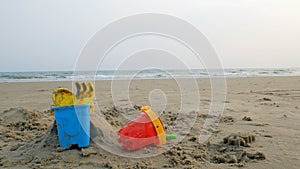 Toys on the sand beach with sea wave select focus shallow depth of field with summer