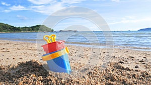 Toys on the sand beach with sea wave select focus shallow depth of field with summer atmosphere