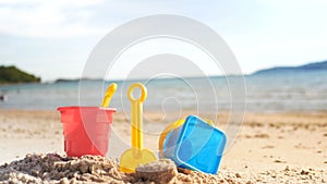 Toys on the sand beach with sea wave select focus shallow depth of field with summer atmosphere