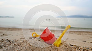 Toys on the sand beach with sea wave select focus shallow depth of field with summer evening atmosphere