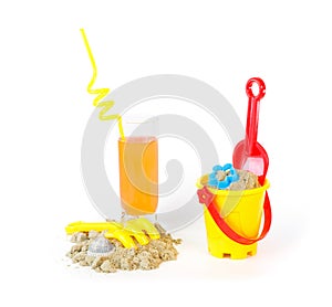 Toys for sand castles and a refreshing drink