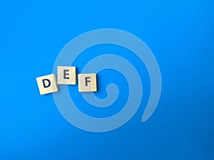 Toys word with word DEF on blue background