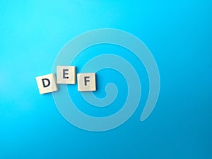 Toys word with word DEF on blue background