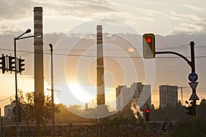 TPP thermal power plant on a sunrise. Refinery with smokestacks. Smoke from factory pollutes the environment. High red and white t